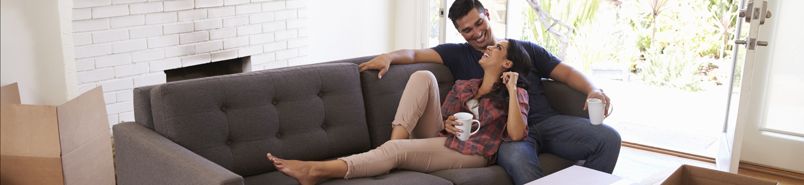 photo of couple relaxing on the couch at home