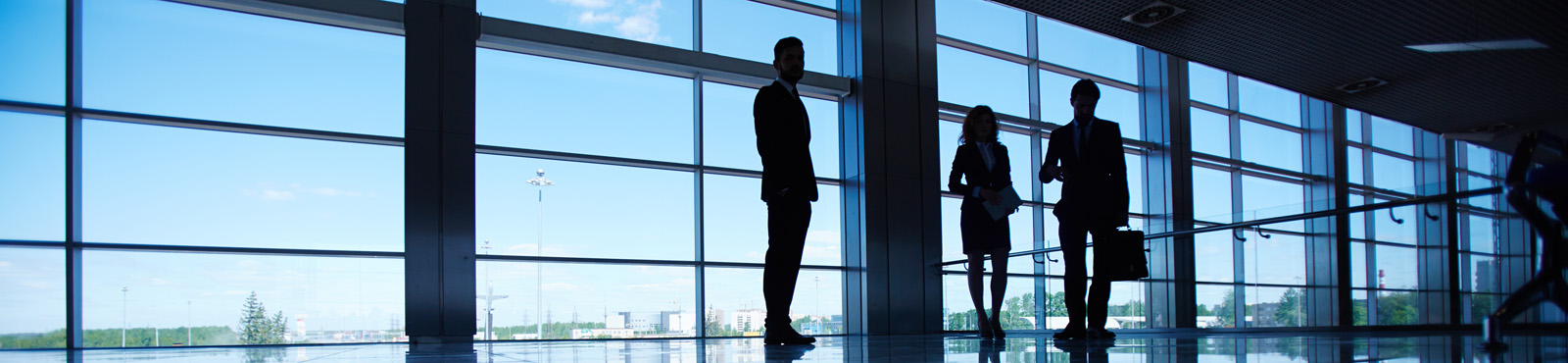 photo of business people silhouettes in front of a large window